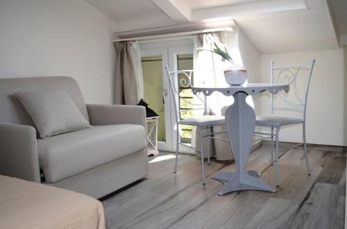 a living room with a table and a couch at Appartamenti Barzilai in Gabicce Mare
