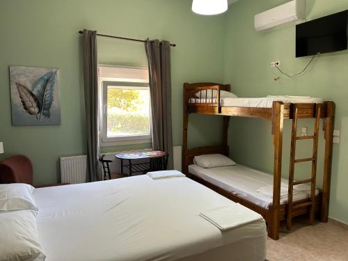 a bedroom with two bunk beds and a window at Akrotiri Studios in Samothraki