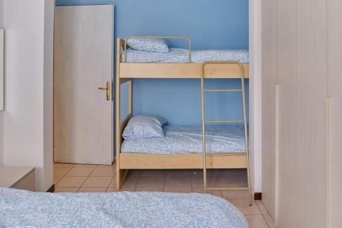 two bunk beds in a room with a bed at Beach 300m Piazza Milano in Lido di Jesolo