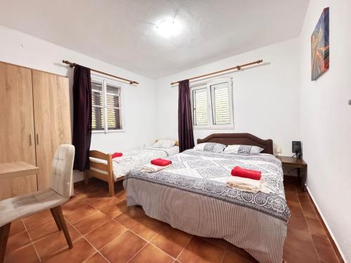 a bedroom with a bed and a chair in it at Bay Mola Aparts in Kotor