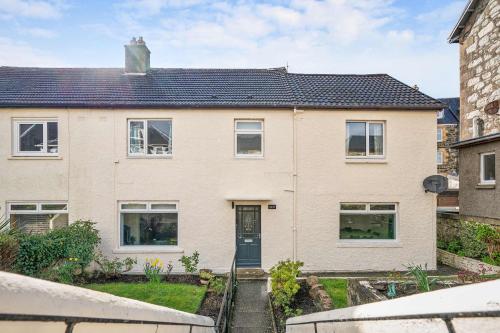 a large brick house with a black door at 4-Bed Home Central Location & Garden in Oban