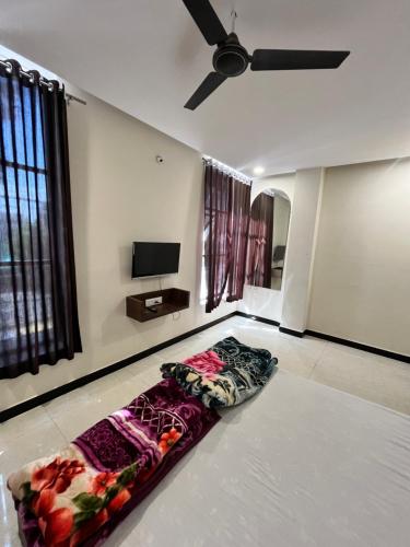 a room with a bed on the floor with a ceiling at Hotel Jaya shree in Ujjain