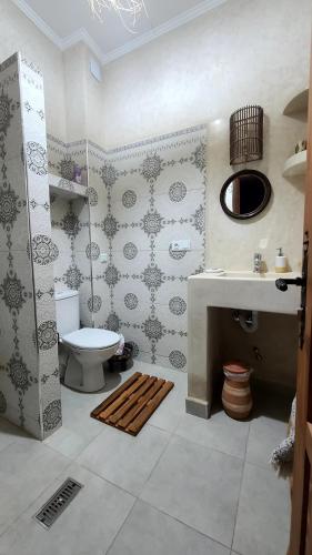 a bathroom with a toilet and a sink at Ryad Fnina in Tiznit