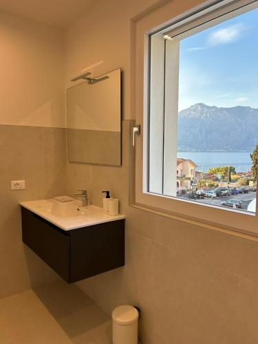 a bathroom with a sink and a window with a view at Casa Nane in Malcesine