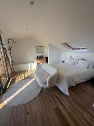 a bedroom with a bed and a chair and a television at Apartamento Casa Norte in O Grove