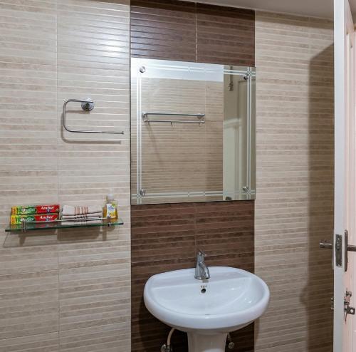 a bathroom with a sink and a mirror at Hill View Vythiri Holiday Home in Vythiri
