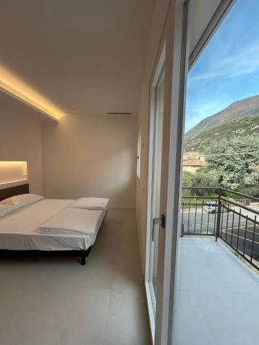 a bedroom with a bed and a balcony with a view at Casa Nane in Malcesine
