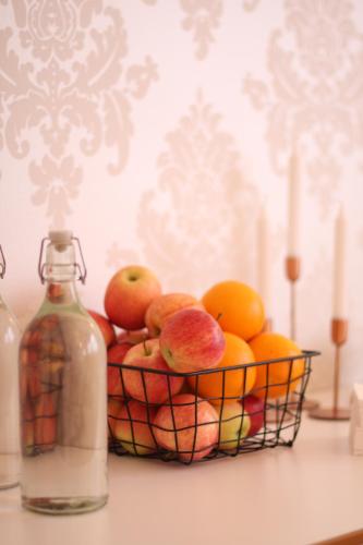 a basket of fruit next to a bottle of water at Best Western Plaza Hotel in Eskilstuna