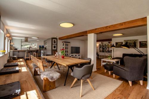 a dining room and living room with a table and chairs at Danielenhof1701, Ferienwohnung Bruckbach in Breitnau