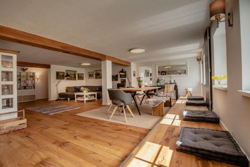 a living room with a table and a dining room at Danielenhof1701, Ferienwohnung Bruckbach in Breitnau