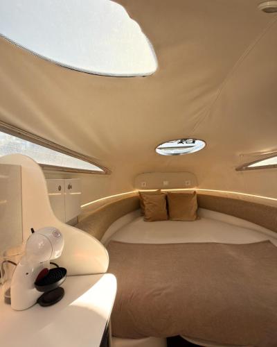 a small room with a bed and a table at HouseBoat on the river-DouroHeritage in Porto