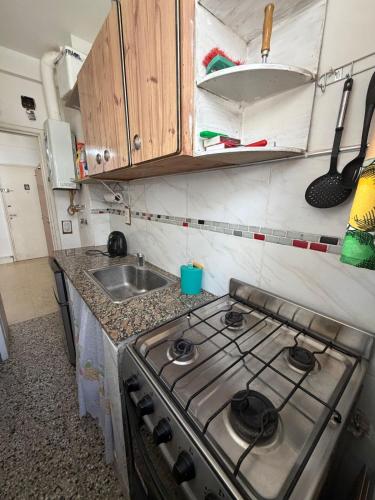 a kitchen with a stove and a sink at Zona centro #N in Mar del Plata