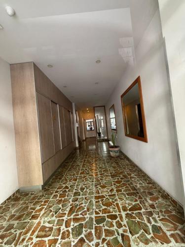 an empty hallway with a stone floor in a building at Zona centro #N in Mar del Plata