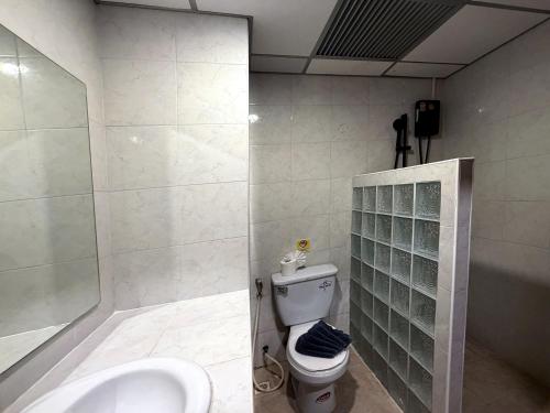 a bathroom with a toilet and a sink at Karon Place in Karon Beach