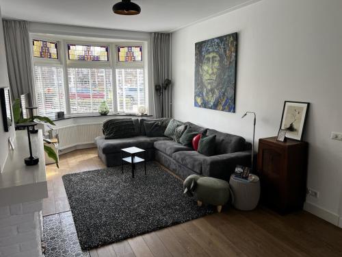 a living room with a couch and a rug at Holiday Home in Center Haarlem near Bloemendaal-Zandvoort Beach private garden in Haarlem