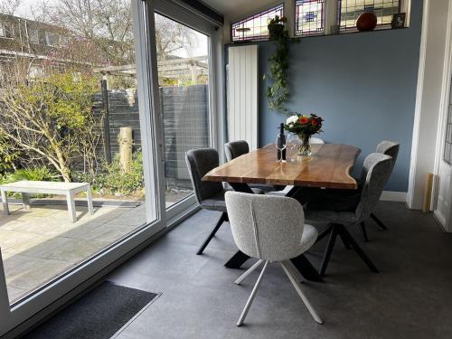 a dining room with a wooden table and chairs at Holiday Home in Center Haarlem near Bloemendaal-Zandvoort Beach private garden in Haarlem