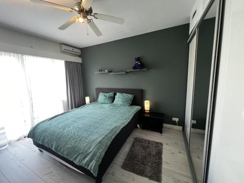 a bedroom with a bed and a ceiling fan at Holiday Home in Center Haarlem near Bloemendaal-Zandvoort Beach private garden in Haarlem