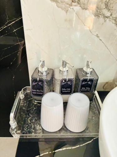 a couple of containers on a tray in a bathroom at Happy House in Cam Lâm