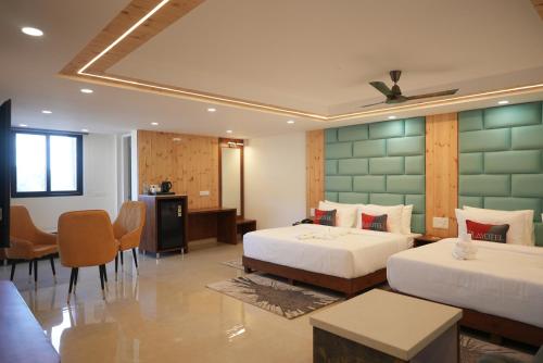 a hotel room with two beds and a table and chairs at Parag Resort Kasauli in Solan