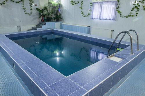 a large swimming pool with blue tile around it at Motel Lesnoy in Odintsovo