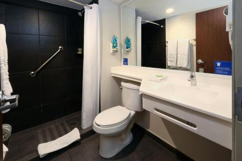 a bathroom with a toilet and a sink and a shower at City Express by Marriott Ciudad Victoria in Ciudad Victoria