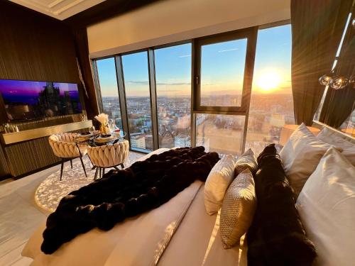 a bedroom with a bed with a view of a city at Sky Suite 22 Hanza Tower in Szczecin