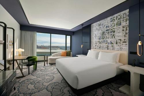 a hotel room with a bed and a desk at The Alexander, Autograph Collection in Indianapolis