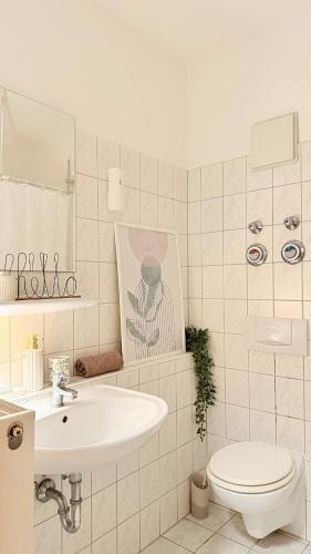 a white bathroom with a sink and a toilet at Apartment in Leipzig in Leipzig
