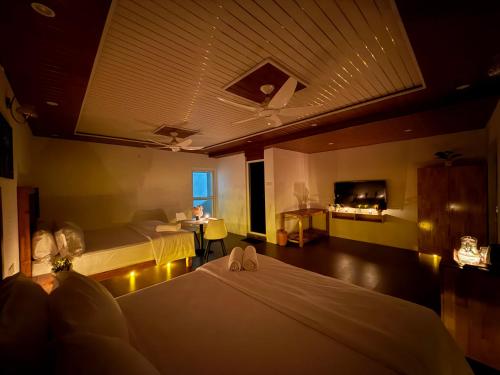 a hotel room with two beds and a television at Misty Garden Retreat in Nandigunda
