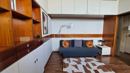 a living room with a blue couch and a table at Residenza 402 in Ivrea