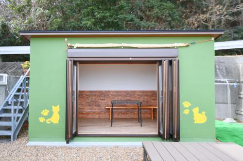 a smallshed with a table inside of it at シーサイド興津 in Sanuki