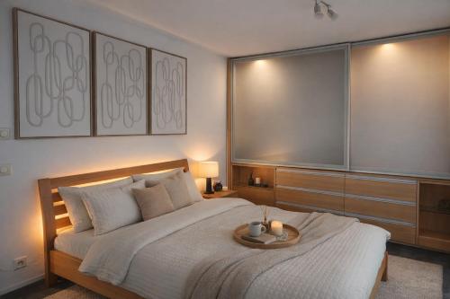 a bedroom with a large bed with a tray on it at Apartment Auszeit nahe Faaker See 24h Self Check-in in Latschach