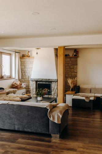 a living room with a fireplace and a couch at Ta Chalupa in Prostřední Bečva