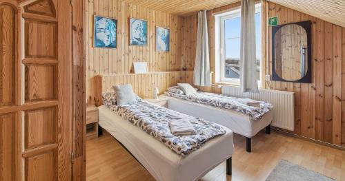 a room with two beds and a window at Guesthouse Kiljan in Blönduós