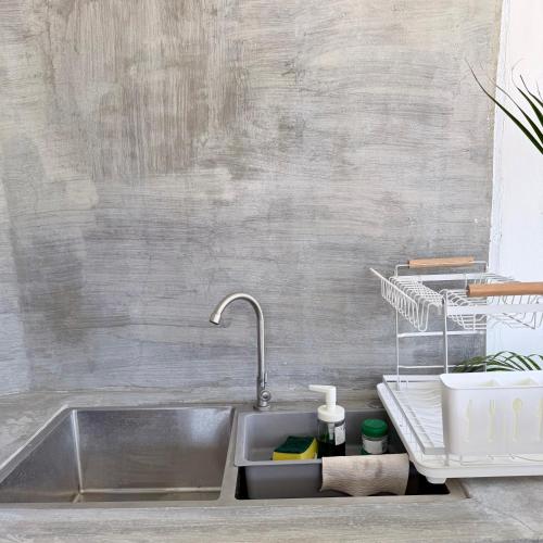 a kitchen sink with a faucet in it at BeaMare Suites in Bantay