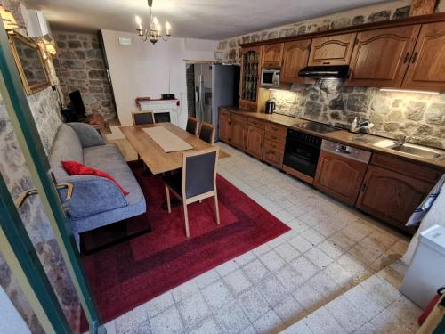 a kitchen with a table and a couch and a dining room at Authentico Deluxe Stari Grad in Stari Grad