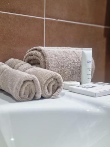 a bathroom with towels and a thermometer on a counter at Wild Haven Lodge in Victoria Falls