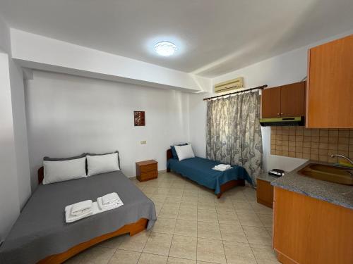 a bedroom with a bed and a sink in a room at Villa Earta & Leo Ksamil in Ksamil