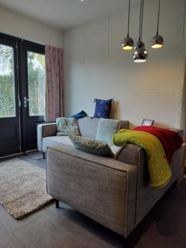 a living room with a couch with pillows on it at Zonnehoek in Bruinisse