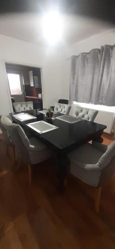 a dining room with a table and a couch at Our Guests Are Royal (EL) Wellingborough in Wellingborough