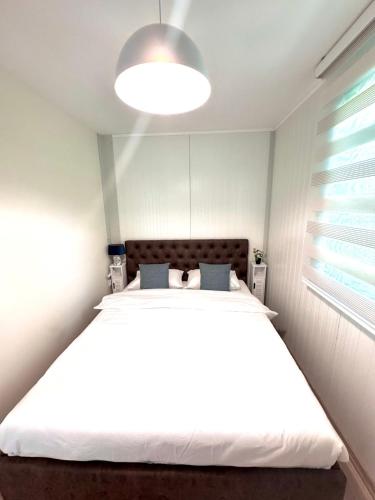 a bedroom with a large white bed in a room at The blue lagoon in Ohrid