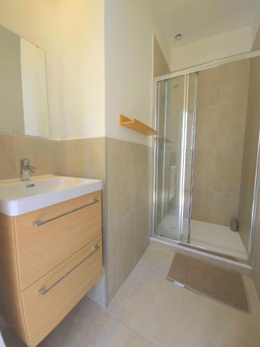 a bathroom with a shower and a sink and a mirror at La Tour d'Harfleur 1 in Caudebec-en-Caux