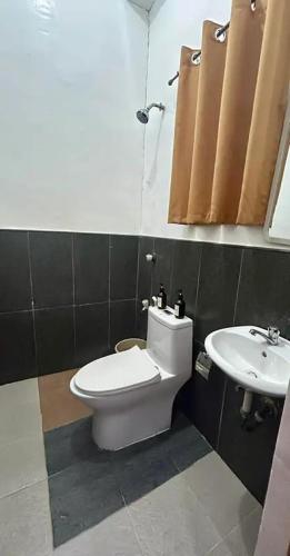 a bathroom with a toilet and a sink at Dodong homestay 2 in General Luna