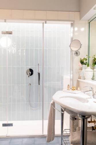 a bathroom with a shower and a sink at Villa Abbazia Relais & Chateaux in Follina