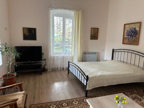 a living room with two beds and a television at Sweet Home in Dilijan