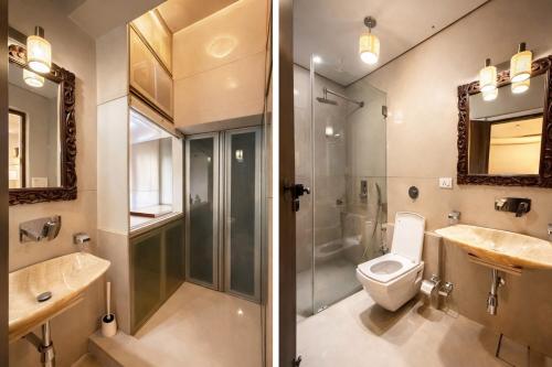 a bathroom with a shower and a toilet and a sink at Pet Friendly Spacious 3 BHK Penthouse in Mumbai