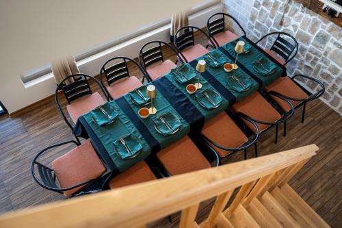 a table with chairs and a green table cloth at VILA K3 Podgorica in Podgorica