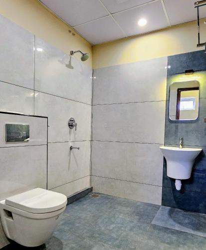 a bathroom with a toilet and a sink at Royal Palace in Chāvasseri