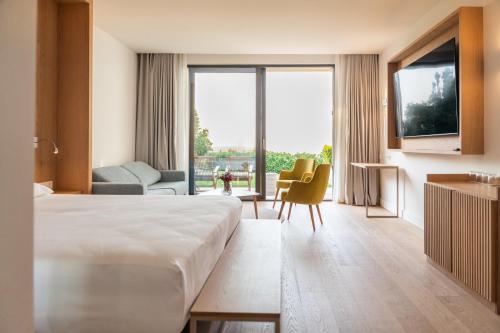 a hotel room with a bed and a large window at PRIVE The Luxury Villa & Boutique Hotel, Cape of Rodon in Draç