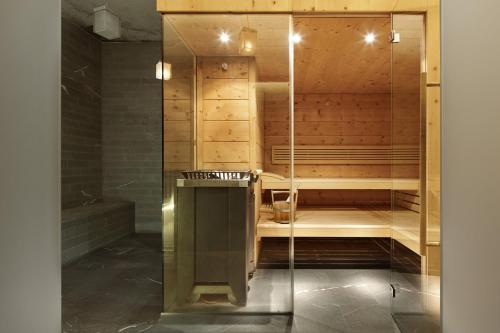 a bathroom with a sauna with a glass wall at Petit Steffani Bed & Breakfast in St. Moritz